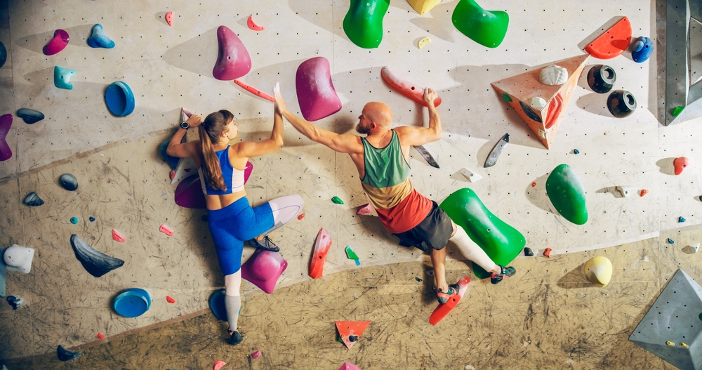 Two,Experienced,Rock,Climbers,Practicing,Climbing,On,Bouldering,Wall,In